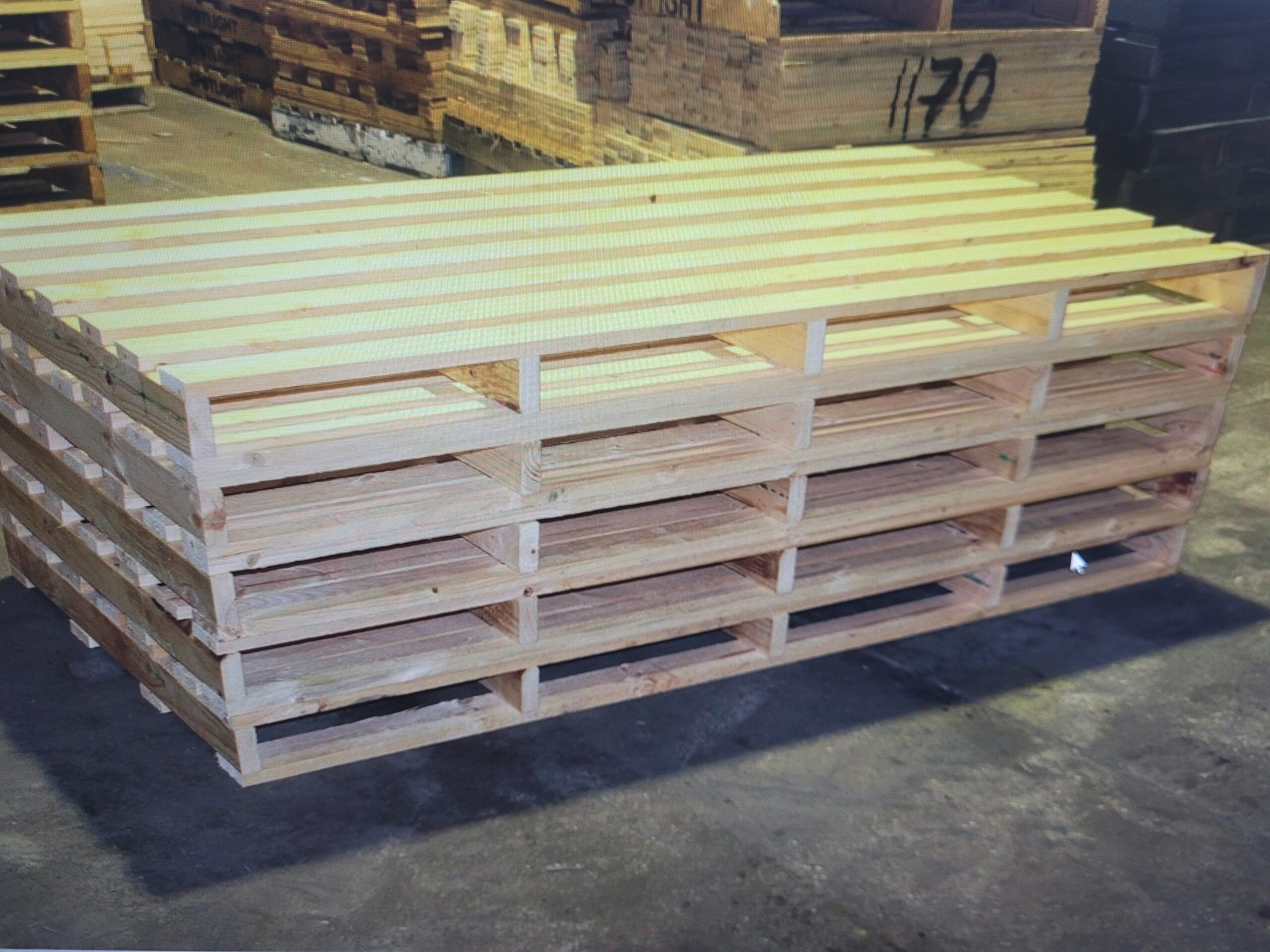 A clean stack of custom wood  pallets for haul off at our location